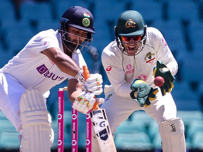 Australia's wicketkeeper Tim Paine drops a catch from India's Rishabh Pant (L) during day five of the third cricket Test match between Australia and India at the Sydney Cricket Ground (SCG) on January 11, 2021. (Photo by DAVID GRAY / AFP) / -- IMAGE RESTRICTED TO EDITORIAL USE - STRICTLY NO COMMERCIAL USE --