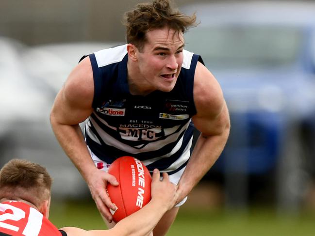 Brodie Hoyne of Macedon is tackled during the round 16 Riddell District Football Netball League 2023 Bendigo Bank Seniors match between Romsey and Macedon at Romsey Park in Romsey, Victoria on August 5, 2023. (Photo by Josh Chadwick)