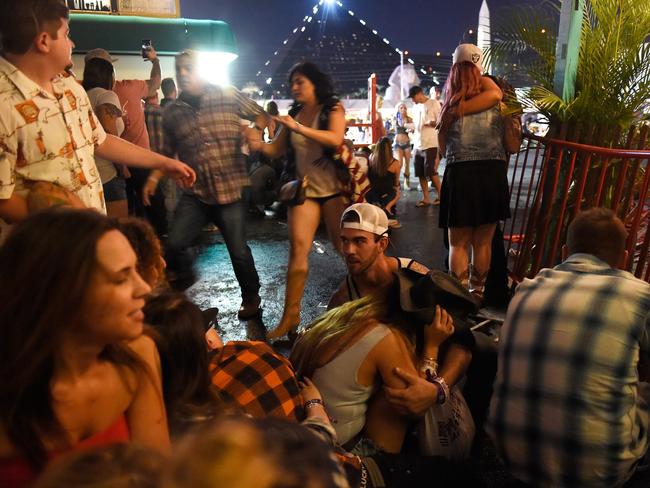 People run for cover at the Route 91 Harvest country music festival after gunfire was heard. Picture: David Becker/Getty Images