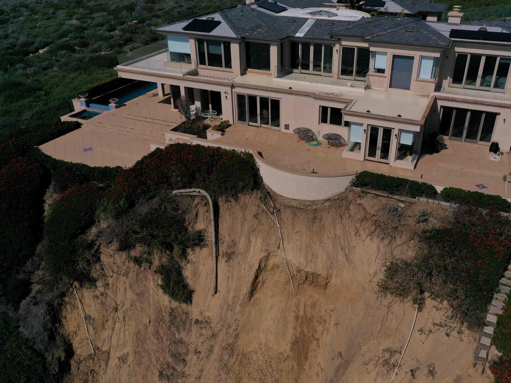 This aerial photograph shows homes along Scenic Drive standing on the edge of a cliff above the Pacific Ocean after a landslide following heavy rains in Dana Point, California, on February 15, 2024. Picture: AFP