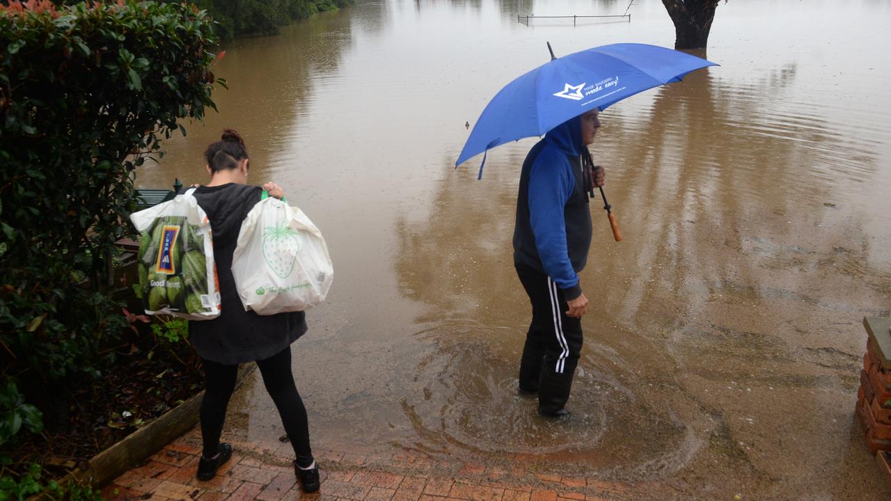 Residents survey the flood waters at McGraths Hill. Picture: NCA NewsWire / Jeremy Piper