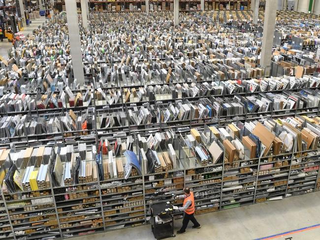 Amazon’s rapid growth over more than two decades prompted President Donald Trump and some policy experts to question how big is too big. Above, an Amazon warehouse in Germany. PHOTO: ULI DECK/DPA/ZUMA PRESS
