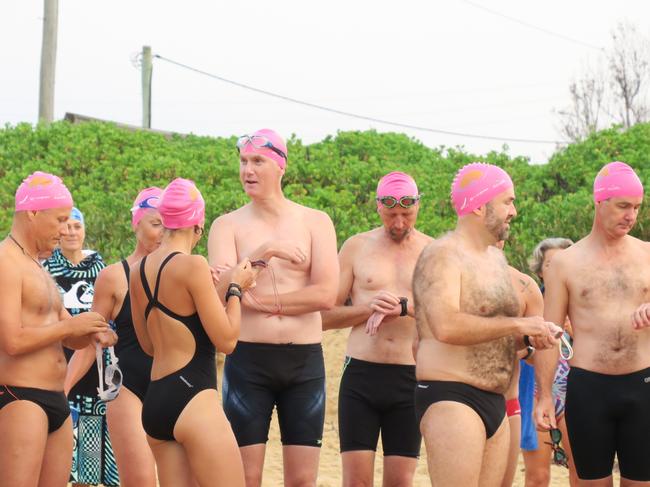 Members of the Peninsula Ocean Swimmers group get ready to attempt to swim around Lion Island. Picture: Richard Noone