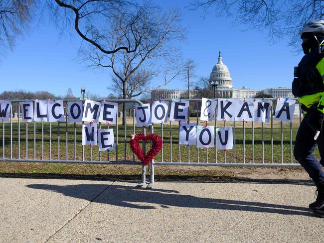 A police officer passes signs of support for President-elect Joe Biden and Vice President-elect Kamala Harris near the US Capital in Washington, DC. Picture: AFP