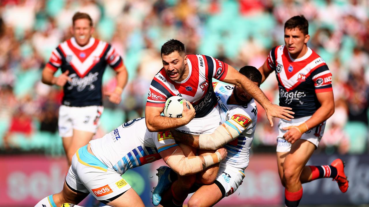 James Tedesco of the Roosters is tackled by the Titans