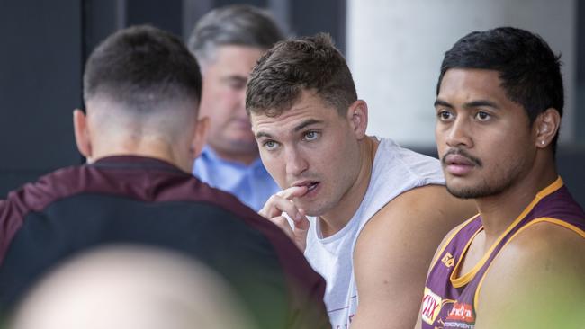 (L-R) Brisbane Broncos players Darius Boyd, Corey Oates and Anthony Milford sit in the cafe at the Clive Berghoffer Centre ahead of a meeting with coach Wayne Bennett on Friday morning. (AAP Image/Glenn Hunt)