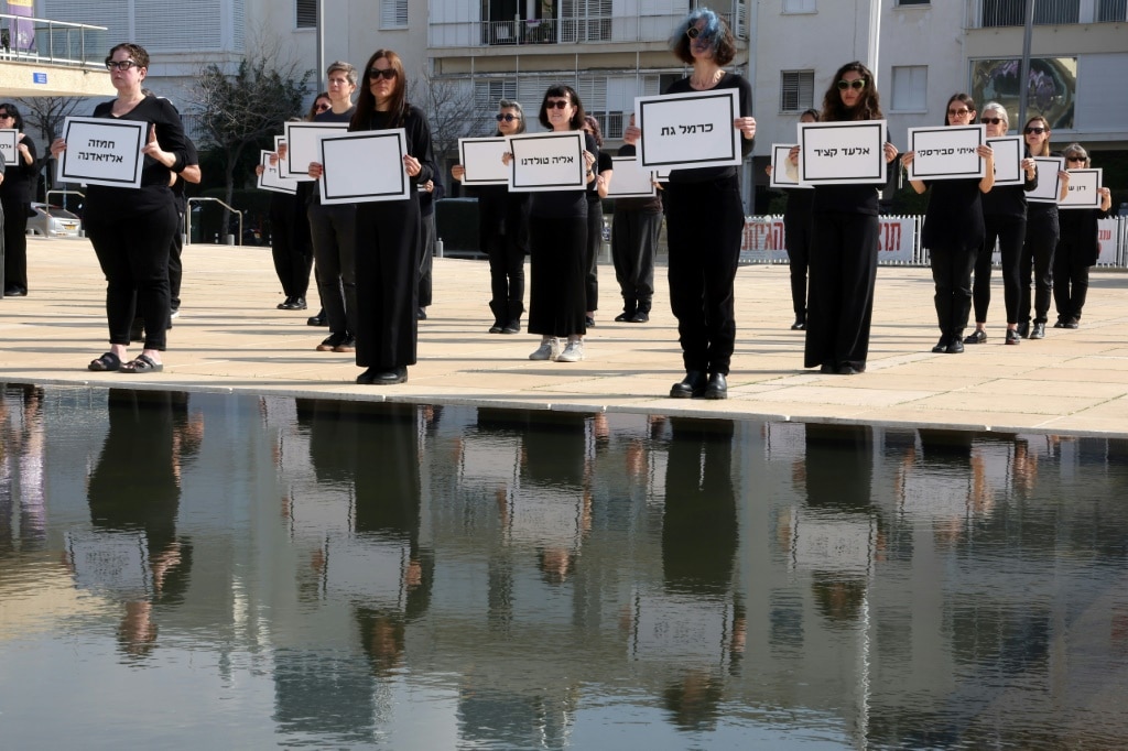 Relatives and supporters of Israelis held hostage in Gaza hold signs bearing the names of hostages believed to be dead, during a demonstration in Tel Aviv demanding action to rescue all captives