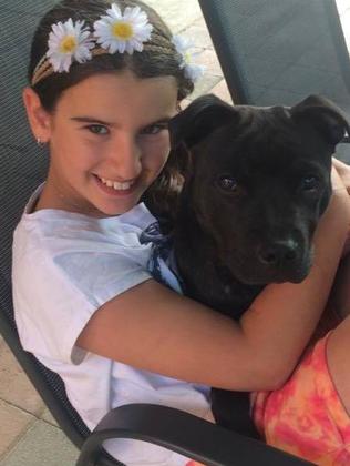 Zoe, with her dog Jax, was described by friends and neighbours as a happy normal little girl. Picture: Facebook