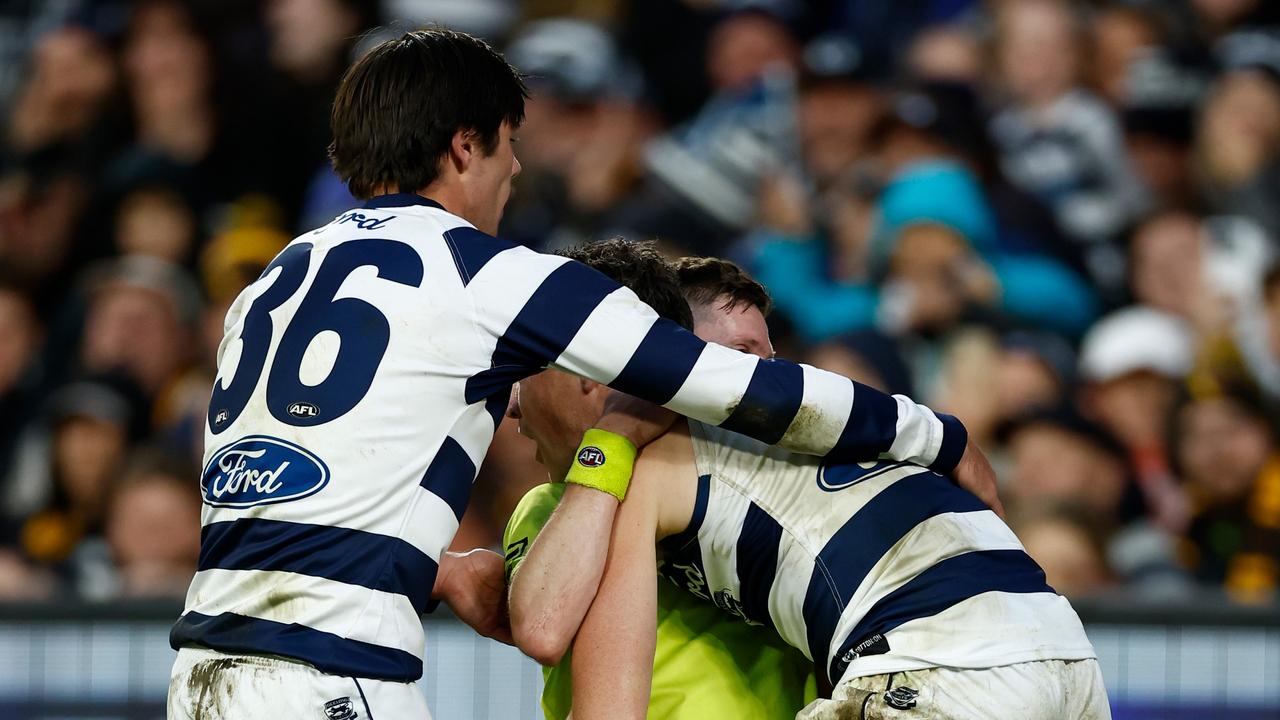 Jeremy Cameron tried to help Matthew Tomkins to his feet. Picture: Michael Willson