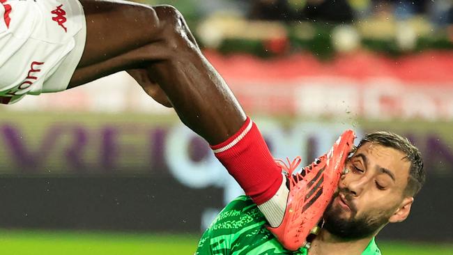 Gianluigi Donnarumma cop a boot to the face in sickening scenes. (Photo by Valery HACHE / AFP)