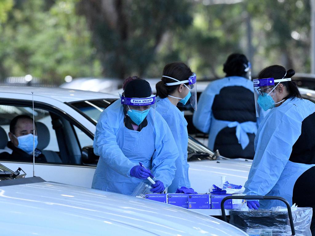 Health workers dressed in personal protection equipment collect patient information prior to Covid-19 testing in Sydney. Picture: NCA NewsWire/Bianca De Marchi