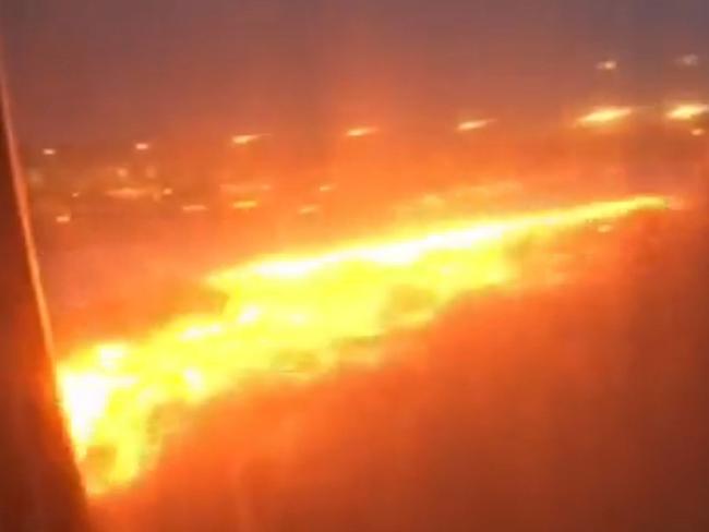 This handout image taken from video and received from passenger Lee Bee Yee on June 27, 2016 shows the right wing of a Singapore Airlines plane on fire on the tarmac of Singapore's Changi Airport. The Singapore Airlines plane caught fire on June 27 while making an emergency landing at Changi Airport after turning back from a flight to Milan following an engine oil warning message, the carrier said. No one was injured aboard the Boeing 777-300ER, but one passenger described those moments as a "so-close to death" experience. / AFP PHOTO / Lee Bee Yee/premiummall.sg / Lee Bee Yee / -----EDITORS NOTE --- RESTRICTED TO EDITORIAL USE - MANDATORY CREDIT "AFP PHOTO / Lee Bee Yee / premiummall.sg" - NO MARKETING - NO ADVERTISING CAMPAIGNS - DISTRIBUTED AS A SERVICE TO CLIENTS - NO ARCHIVES