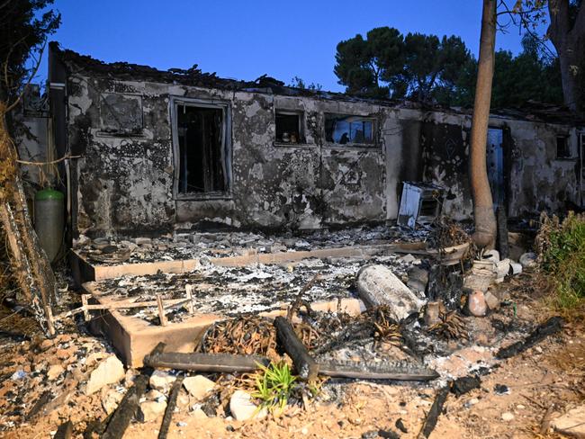 A house is completely destroyed after being burned by Hamas militants during the attack.