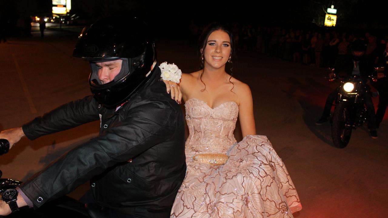 Brittany Irwin arrives on a motorbike at the St John's Formal in Roma.