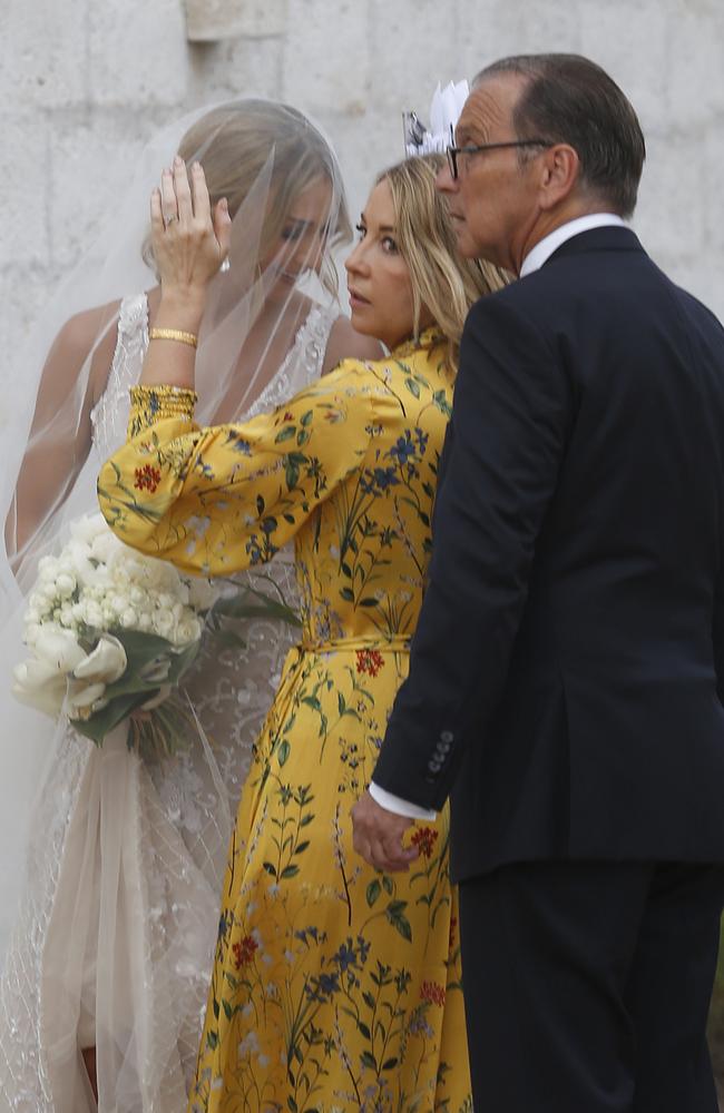 Heinrich was seen clutching a bouquet of white flowers. Picture: Matrix