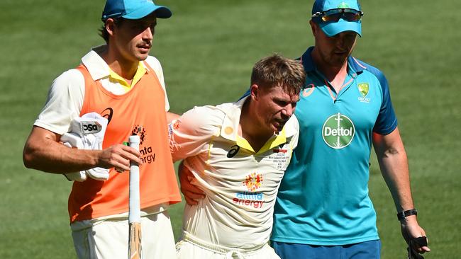 David Warner is helped off the field in Melbourne, Australia. (Photo by Quinn Rooney/Getty Images)