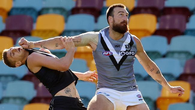 Port Adelaide spearhead Charlie Dixon holds Liam Jones out of a contest.