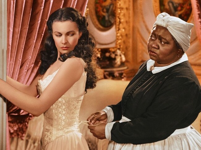 A scene from the 1939 film Gone With the Wind showing Scarlett (Vivien Leigh) being laced into a corset by Mammy (Hattie McDaniel). Picture: Supplied