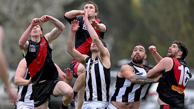 Riddell and Wallan players fly for the mark. Picture: Andy Brownbill