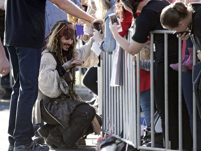 Johnny Depp greets fans after returning from a day on the film set of Pirates of the Caribbean. Picture: AFP