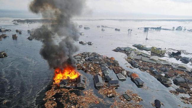 Houses were swallowed by tsunami waves and burned in Natori, Miyagi Prefecture (state) after Japan was struck by a strong earthquake off its northeastern coast on March 11, 2011. Picture: Kyodo News