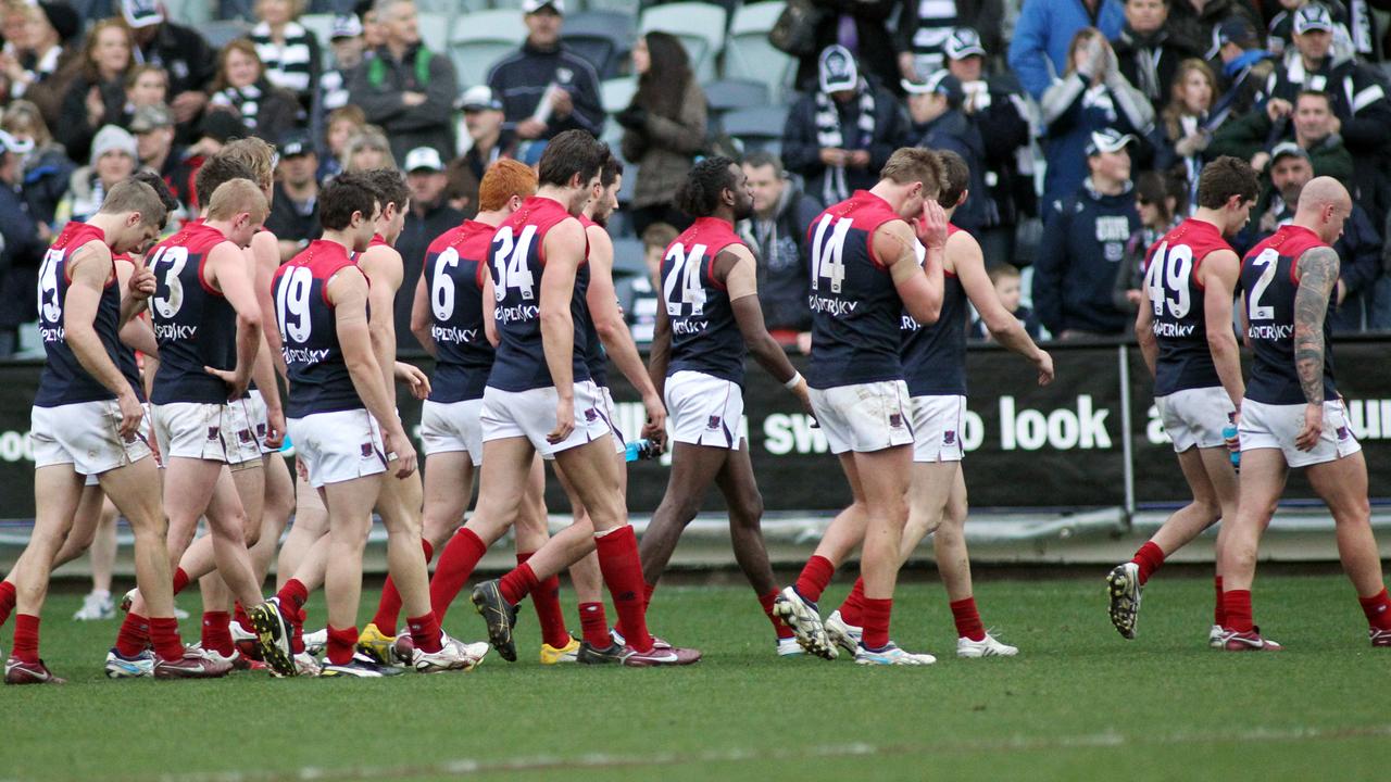 The Melbourne team leave the field after a big loss in 2011. Picture: David Crosling