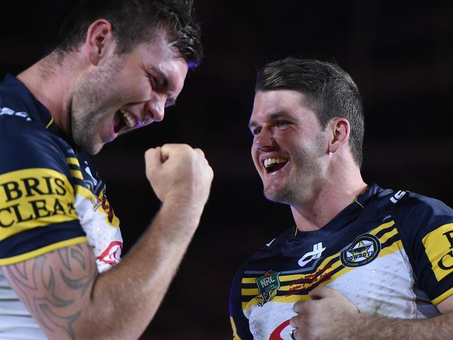 Kyle Feldt and Lachlan Coote and celebrate after their win over the Broncos.