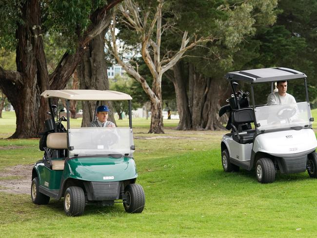 Recreational golfers drive one cart each as they play on a bayside golf course in Melbourne, Wednesday, March 25, 2020. Australia will be placed into an even tighter lockdown from midnight on Wednesday night as governments desperately try to slow the spread of the coronavirus. (AAP Image/Michael Dodge) NO ARCHIVING