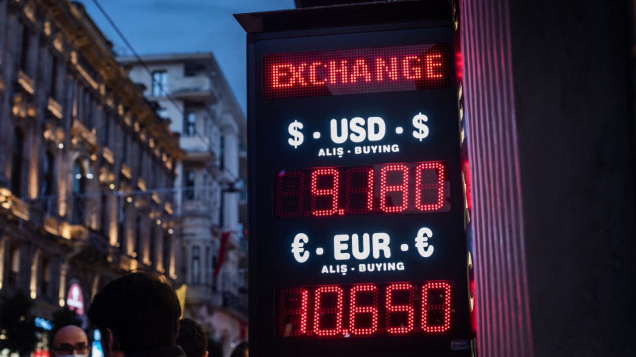 Illuminated sign showing the Turkish Lira currency exchange rate with the Dollar and Euro near Taksim Square, Istanbul, Turkey.