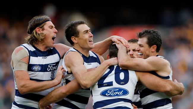 MELBOURNE - APRIL 10: Tom Hawkins of the Cats cgwt\\ Jeremy Cameron, Mark Blicavs and Isaac Smith during the 2023 AFL Round 04 match between the Geelong Cats and the Hawthorn Hawks at the Melbourne Cricket Ground on April 10, 2023 in Melbourne, Australia. (Photo by Dylan Burns/AFL Photos via Getty Images)