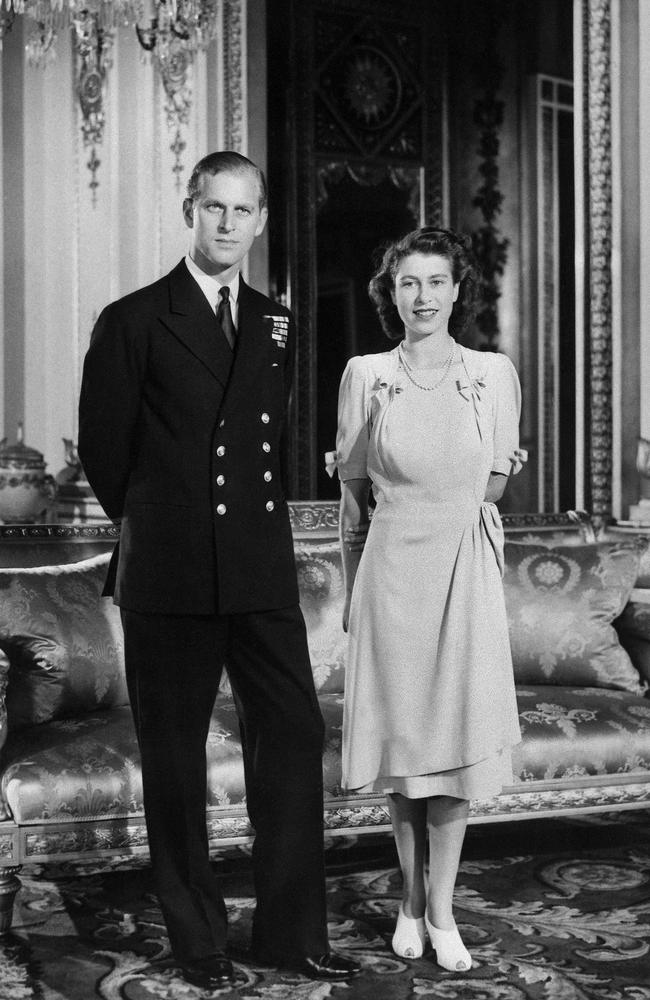 Princess Elizabeth (future Queen Elizabeth II) and her fiance Philip Mountbatten (also the Duke of Edinburgh) pose the Buckingham Palace in London, the day their engagement was officially announced in 1947. Picture: AFP