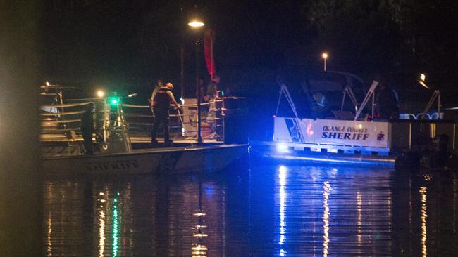 Police officers search for a child who was reportedly pulled into the water by an alligator near Disney's Grand Floridian Resort &amp; Spa in Orlando, Florida. Picture: John Taggart/EPA