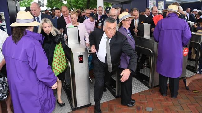 Racegoers run through the gates. Picture: AAP/Julian Smith