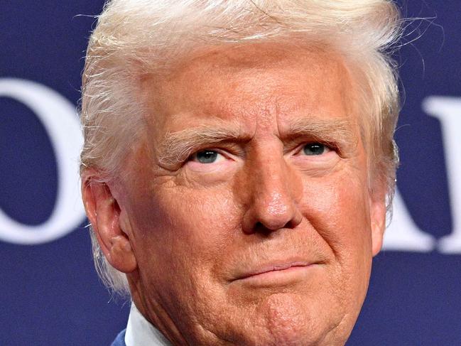 TOPSHOT - US President Donald Trump looks on after delivering remarks at the House Republican Members Conference Dinner at Trump National Doral Miami, in Miami, Florida on January 27, 2025. (Photo by Mandel NGAN / AFP)