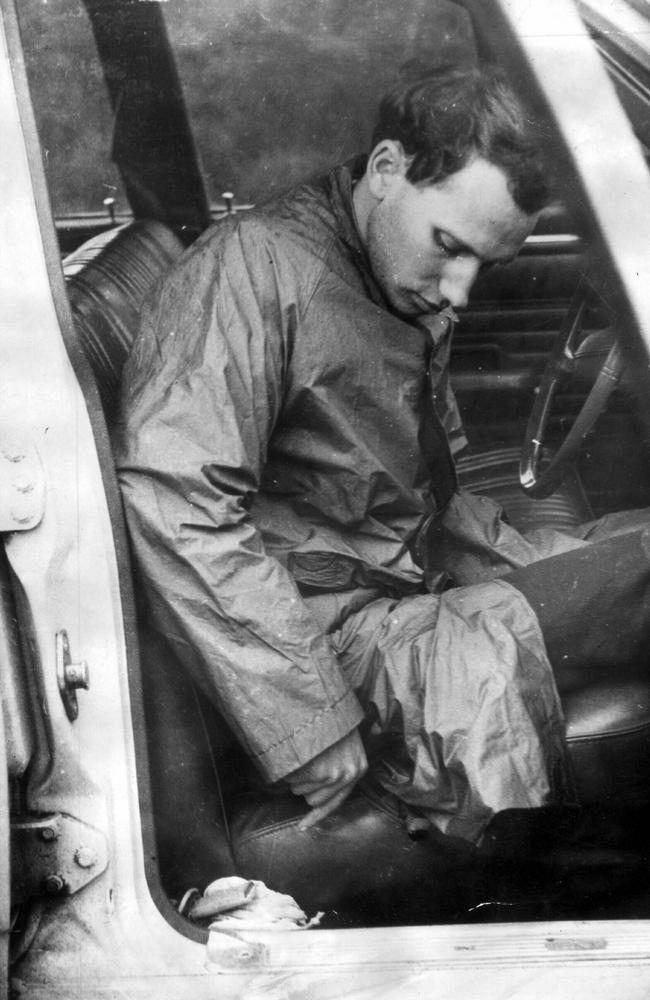 Derek Percy, 21, re-enacts for police the murder of Yvonne Tuohy, 12, in Warneet, Victoria. The photo was taken by detectives at the murder scene two days after Percy's arrest. Here he shows police how he used to keep the murder knife in his car seat.