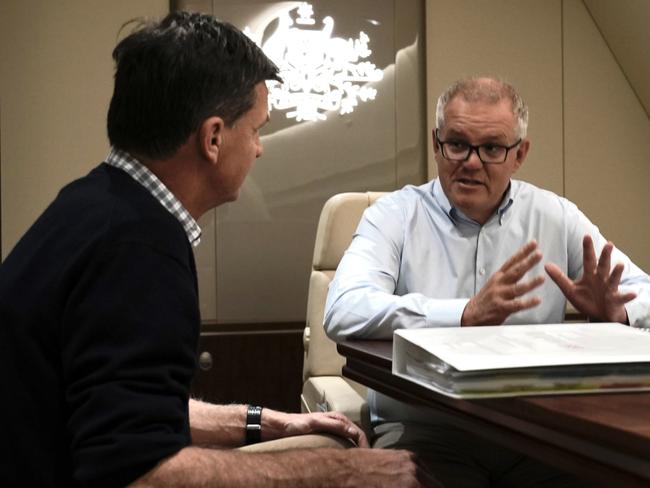 Prime Minister Scott Morrison and Energy Minister Angus Taylor chat in the boardroom on the way to the G20 in Rome then will be heading to the COP26 Climate summit in Glasgow where they will both outline Australia's response to reaching Net Zero by 2050. Picture: Adam Taylor/PMO