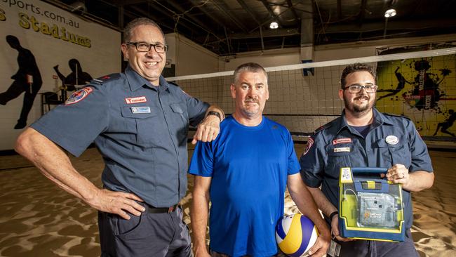 Colin Rooney (centre) with the two paramedics, Paul Viti and Sam Williams, who helped save his life. Picture: Tim Carrafa