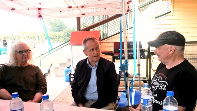 Leader of the Opposition Bill Shorten talks to locals Fiona McAlpine and Frederick Leech at the Huonville evacuation centre. Picture: LUKE BOWDEN