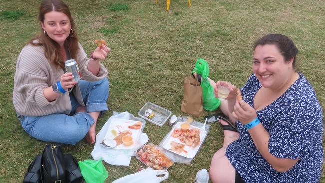 Christina Arnost and Rikki Devoijs enjoying fresh seafood at this year’s Seafood Festival.