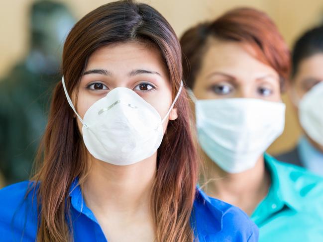 Business people wearing medical masks during flu or contagious pandemic