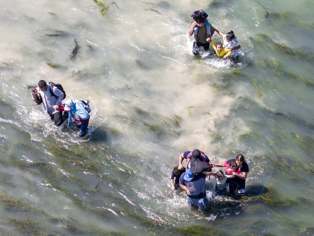 Immigrants struggle through the current of the Rio Grande while crossing from Mexico into Texas, USA. Picture: John Moore/Getty Images