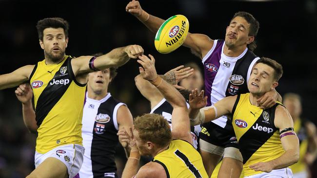 Trent Cotchin spoils as teammates crashes into the pack. Picture: Mark Stewart