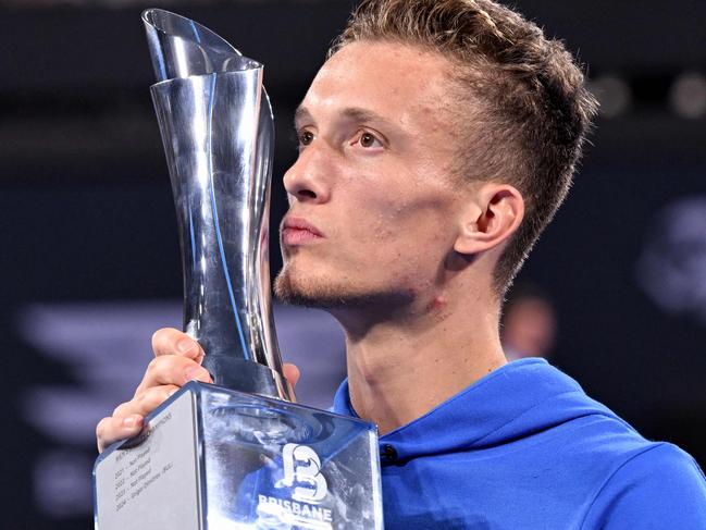 Czech Republic's Jiri Lehecka celebrates with the trophy after defeating USA's Reilly Opelka in their men's singles final match at the Brisbane International tennis tournament on Pat Rafter Arena in Brisbane on January 5, 2025. (Photo by William WEST / AFP) / -- IMAGE RESTRICTED TO EDITORIAL USE - STRICTLY NO COMMERCIAL USE --