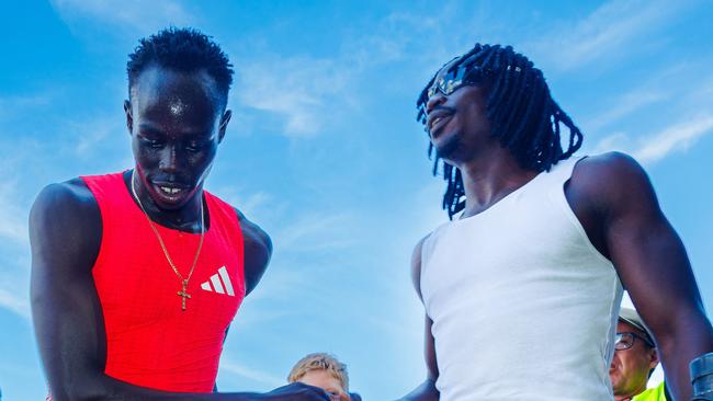 Australian sprinter Gout Gout (L) shakes hands with a fan.