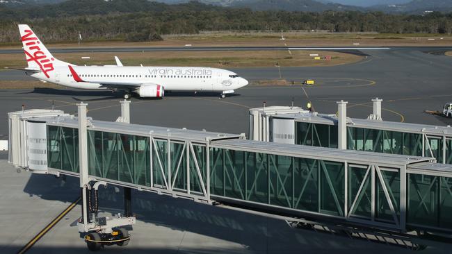 A Virgin Australia flight passes new aerobridges at Gold Coast Airport. Picture: Glenn Hampson.