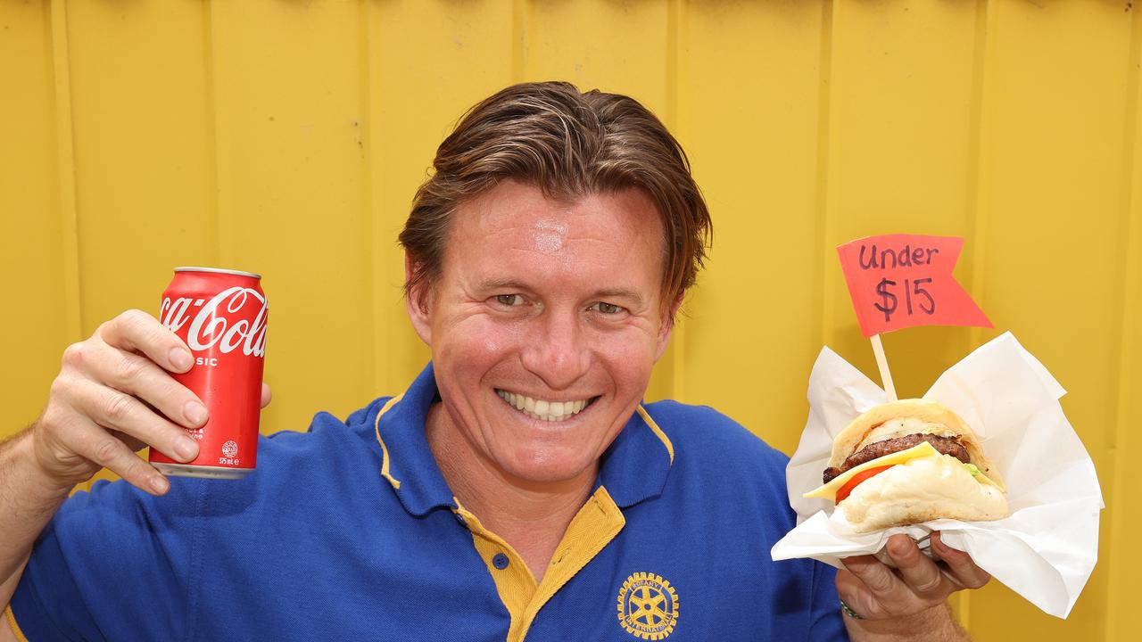 Geelong East Rotary member Laurent Franklin with a feed for under $15 - a burger with the lot for $9.50 and a can of drink for $2.50 at the Geelong Show. Picture: Alison Wynd