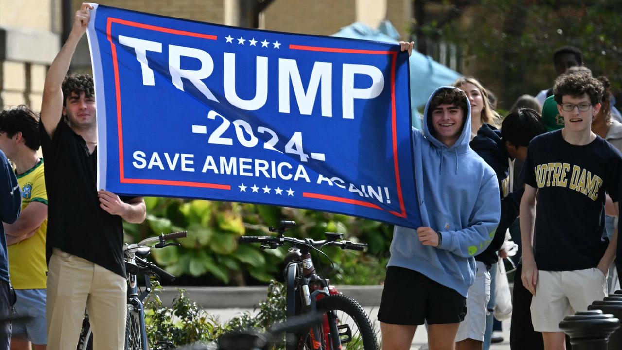 Student supporters of Trump hold a banner. Picture: ANDREW CABALLERO-REYNOLDS / AFP