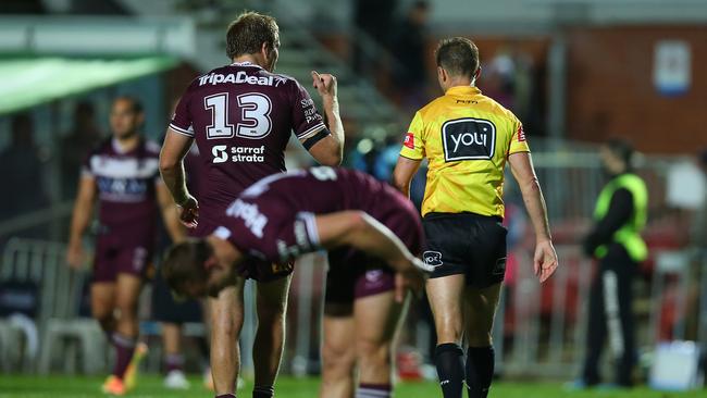 Jake Trbojevic (No. 13) of the Sea Eagles speaks to referee Grant Atkins at full time.