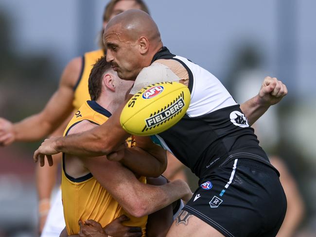 ADELAIDE, AUSTRALIA - FEBRUARY 23:  Mark Keane of the Crows  tackled by Willie Rioli of the Power and  Sam Powell-Pepper of the Power causing a concussion during an AFL practice match between Port Adelaide Power and Adelaide Crows at Alberton Oval on February 23, 2024 in Adelaide, Australia. (Photo by Mark Brake/Getty Images)