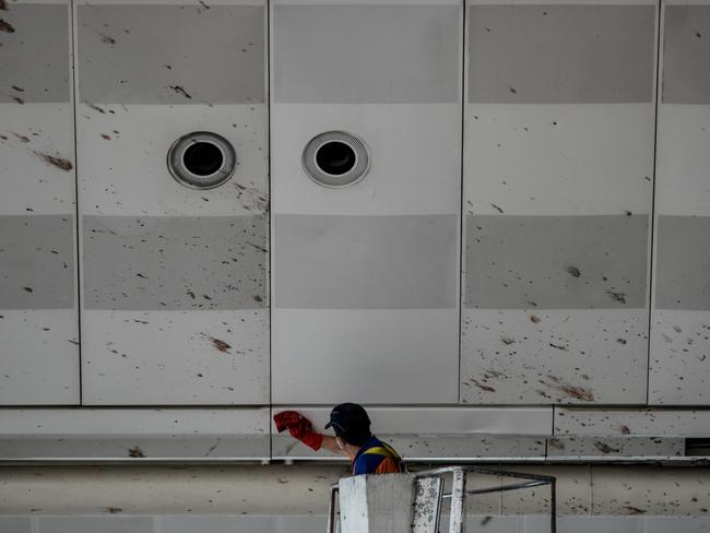 A worker cleans the blood splashed on the roof of the international departure terminal at the country's largest airport, Istanbul Ataturk. Picture: Getty